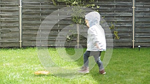 Childhood, leisure, game, yard, spring concept - three young children play in the yard with balls and a fitball on a