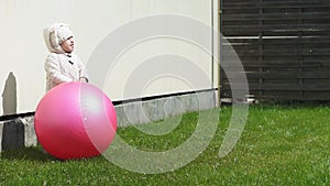Childhood, leisure, game, yard, spring concept - three young children play in the yard with balls and a fitball on a