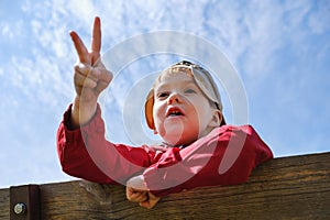 Childhood leisure happy boy kid playing rock-paper-scissors game in park