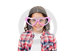 Childhood love concept. Child charming smile fall in love. Girl heart shaped eyeglasses celebrates valentines day. Girl