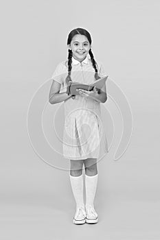 Childhood memories. encyclopedia book for children. girl love literature. old school. happy little girl in retro uniform