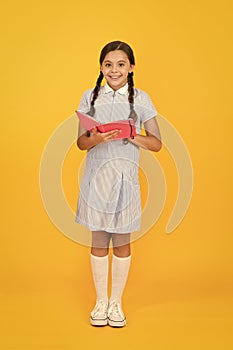 Childhood memories. encyclopedia book for children. girl love literature. old school. happy little girl in retro uniform