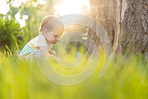 Childhood, nature, summer, parks and outdoors concept - portrait of cute blond-haired little boy in striped multi