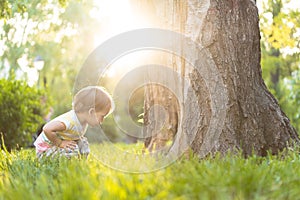 Childhood, nature, summer, parks and outdoors concept - portrait of cute blond-haired little boy in striped multi