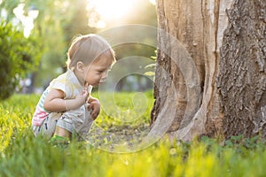 Childhood, nature, summer, parks and outdoors concept - portrait of cute blond-haired little boy in striped multi