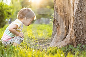 Childhood, nature, summer, parks and outdoors concept - portrait of cute blond-haired little boy in striped multi