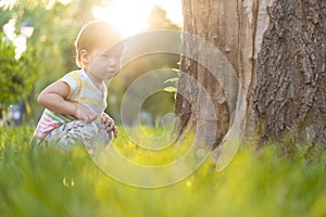 Childhood, nature, summer, parks and outdoors concept - portrait of cute blond-haired little boy in striped multi