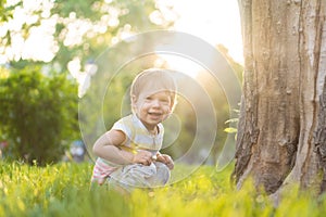 Childhood, nature, summer, parks and outdoors concept - portrait of cute blond-haired little boy in striped multi