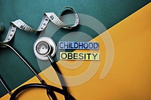 Childhood Obesity text on top view color table and Healthcare/medical concept photo