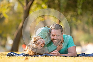 Childhood and parenthood kids concept. Happy father and son playing together outdoor. Children love parents, affection