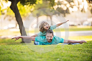 Childhood and parenthood kids concept. Happy father and son playing together outdoor. Concept of friendly family.