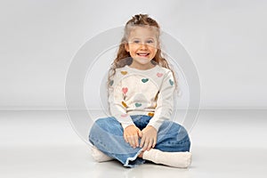 Beautiful smiling girl sitting on floor