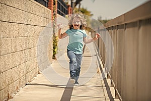 Childhood play. Happy boy have fun running on promenade. Outdoor play. Summer activities