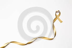 childhood ribbon, gold ribbon as symbol of childhood cancer awareness isolated on white background