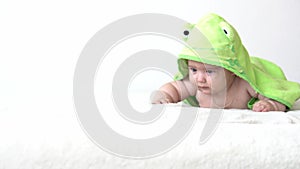 Childhood, daily routine, hygiene infant concepts - Close-up Happy kid colored towel of green frog on white background