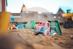 Childhood sandbox concept: Close up of plastic toy truck