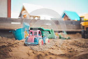 Childhood sandbox concept: Close up of plastic toy truck photo