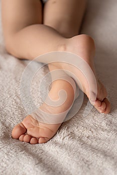 Childhood, sleep, relaxation, family, lifestyle concept - Bare feet of little sleeping girl