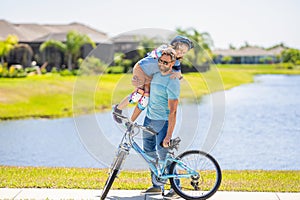 childhood of son supported by fathers care. father and son on bicycle at fathers day. active father setting a example