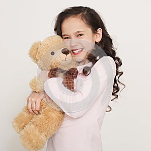 Cute little girl hugging teddy bear