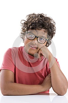 Childhood, vision, , education and people concept - happy smiling boy in red t-shirt in eyeglasses