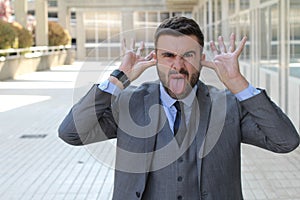 Childish businessman doing an obscene gesture photo