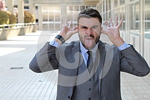 Childish businessman doing an obscene gesture