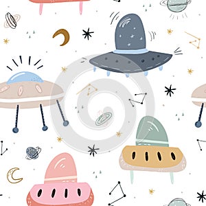 Childish seamless pattern with aliens, ufo in cosmos. Perfect for kids apparel,fabric, textile, nursery decoration,wrapping paper photo
