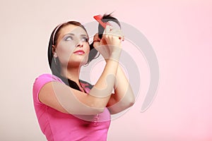 Childish woman infantile girl combing hair. Longing for childhood.