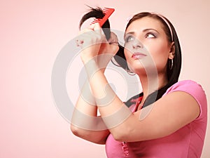 Childish woman infantile girl combing hair. Longing for childhood.