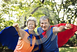 Childlike seniors wearing superhero costumes