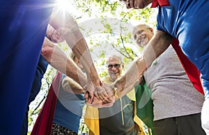 Childlike seniors wearing superhero costumes