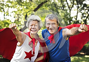 Childlike seniors wearing superhero costumes