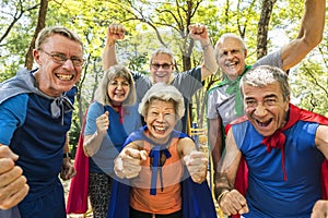 Childlike seniors wearing superhero costumes