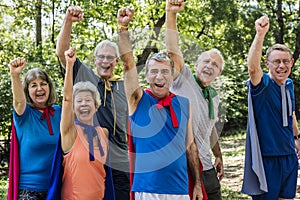 Childlike seniors wearing superhero costumes