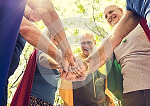 Childlike seniors wearing superhero costumes