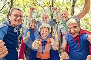 Childlike seniors wearing superhero costumes