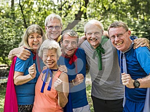 Childlike seniors wearing superhero costumes