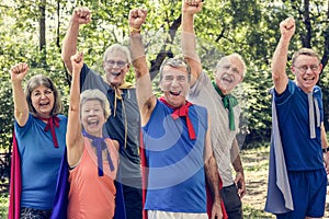 Childlike seniors wearing superhero costumes