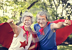 Childlike seniors wearing superhero costumes photo