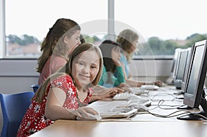 Children (10-12) using computer in computer lab