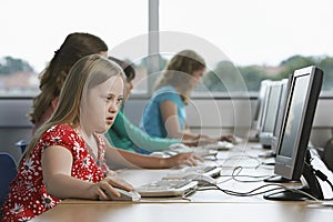 Children (10-12) using computer in computer lab