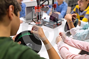 Children with 3d printer at robotics school