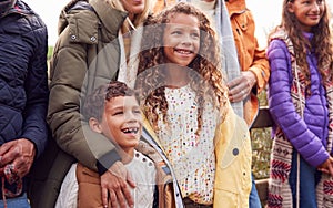 Children With  Active Multi-Generation Family On Winter Beach Vacation Resting By Gate