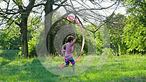 Children activities, joyful boy with tape running on green lawn in forest