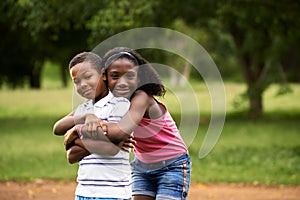Children african boy and girl in love hugging