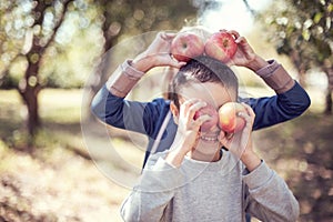 Children with Apple in Orchard. Harvest Concept