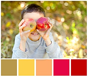 Children with Apple in Orchard. Harvest Concept