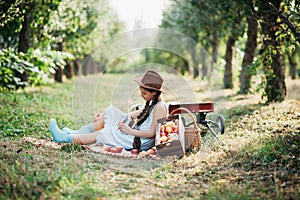 Children with Apple in Orchard. Harvest Concept