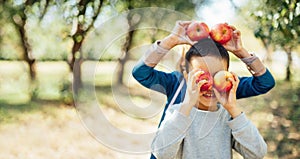 Children with Apple in Orchard. Harvest Concept.